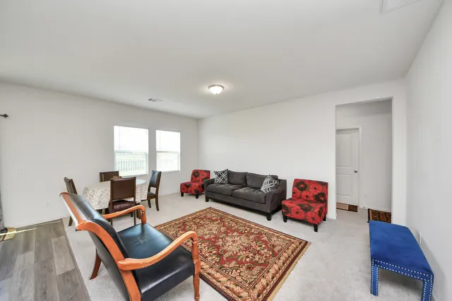 a living room with furniture flat screen tv and a table
