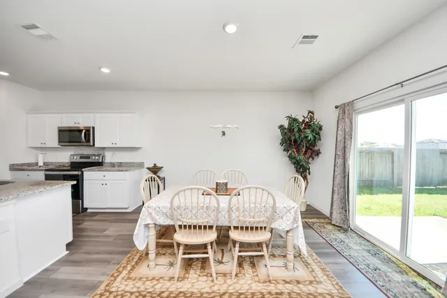 a view of a dining room with furniture window and wooden floor