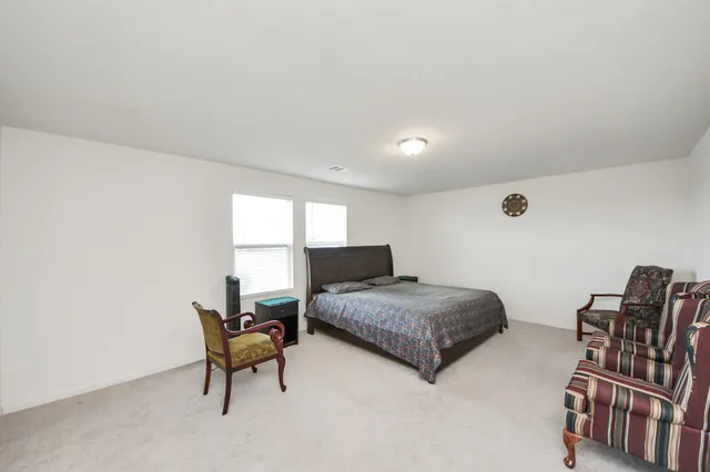 a living room with furniture and a piano