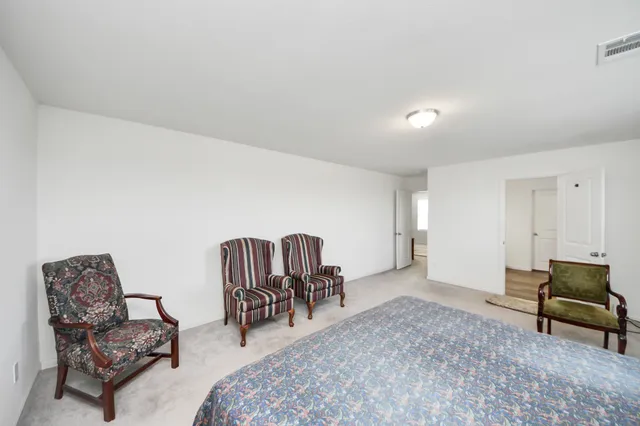 a bathroom with a sink a toilet and a large mirror