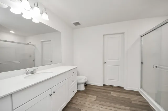 a bathroom with a sink vanity and a mirror