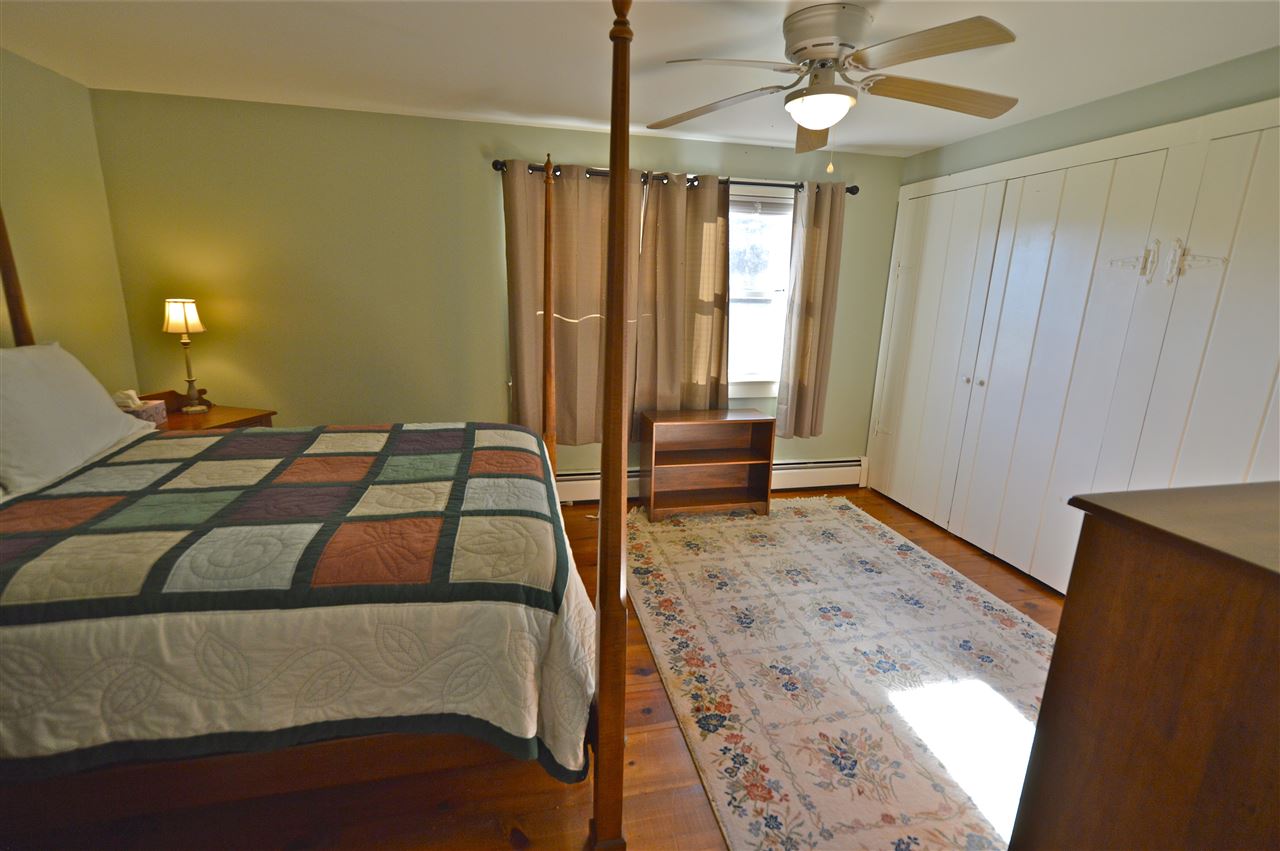 62 Jonestown Road Fairfield, VA 24435 - Photo 23 of 42 a bedroom with a large bed and a chandelier
