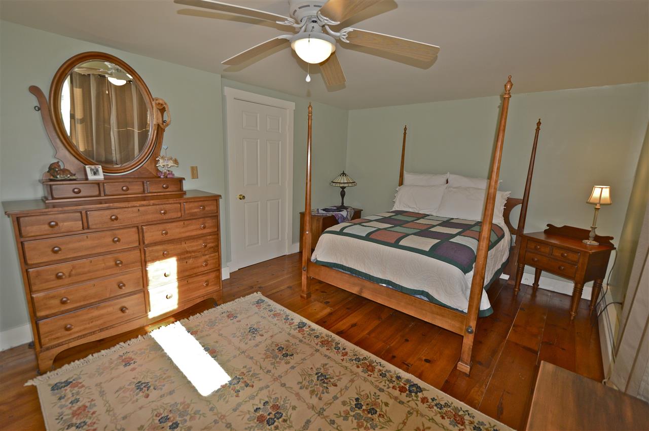 62 Jonestown Road Fairfield, VA 24435 - Photo 24 of 42 a bedroom with a bed a mirror on dresser and a chandelier