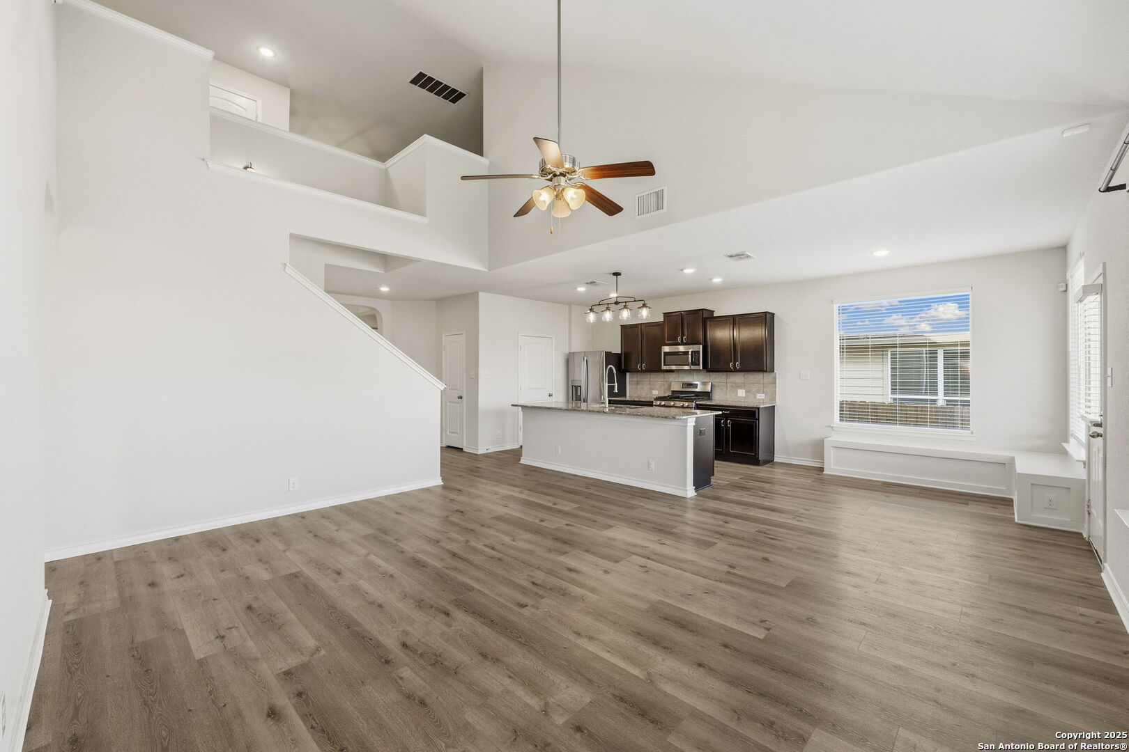 328 Swift Move Cibolo, TX 78108 - Photo 7 of 32 a view of empty room with wooden floor and kitchen view