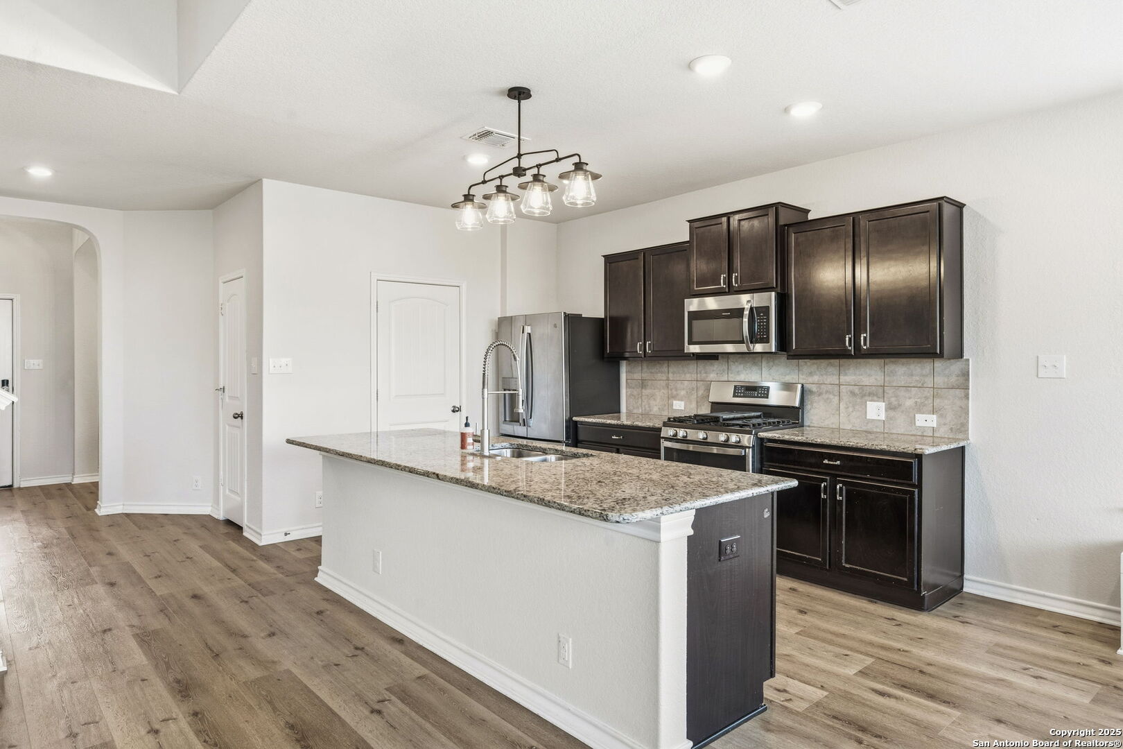 328 Swift Move Cibolo, TX 78108 - Photo 8 of 32 a kitchen with stainless steel appliances granite countertop a sink stove and refrigerator