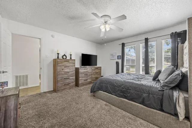 a bed room with a bed and a television