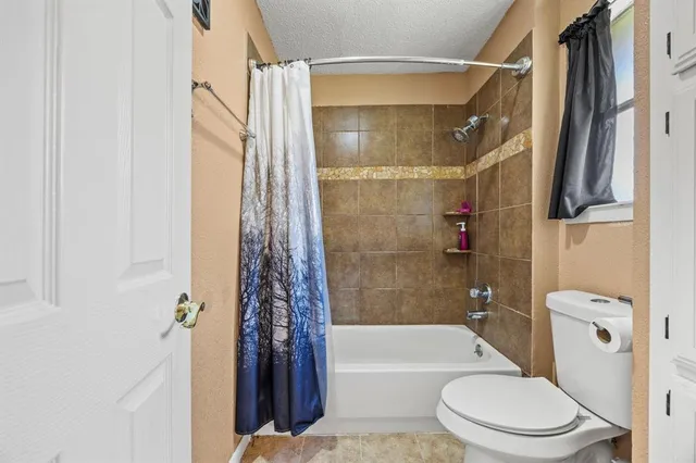 a bathroom with a toilet and a bathtub
