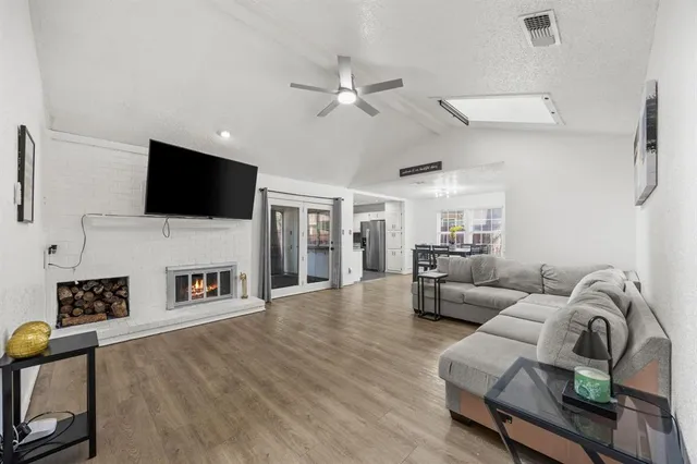 a living room with furniture a fireplace and a flat screen tv