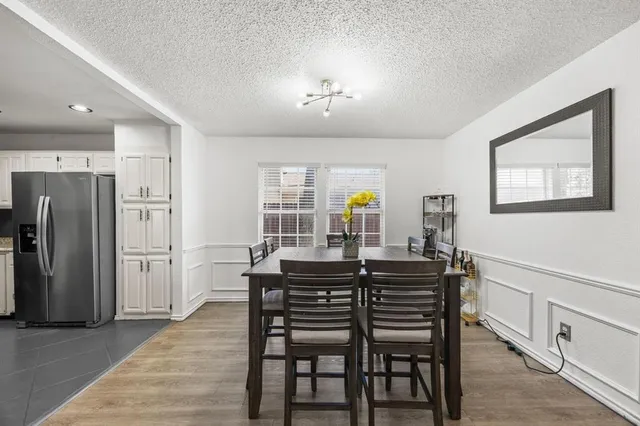 a view of a dining room with furniture and a chandelier