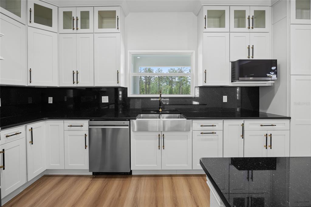 9789 Southwest 125th Ct Road Dunnellon, FL 34432 - Photo 11 of 37 a kitchen with stainless steel appliances a white stove top oven a sink a counter space and cabinets