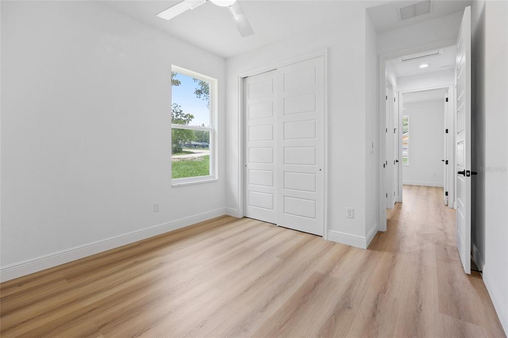 9789 Southwest 125th Ct Road Dunnellon, FL 34432 - Photo 18 of 37 a view of an empty room with wooden floor and a window
