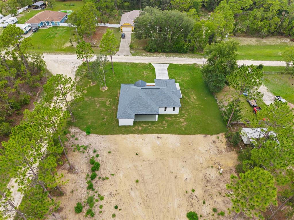 9789 Southwest 125th Ct Road Dunnellon, FL 34432 - Photo 7 of 37 an aerial view of a house with a garden and yard