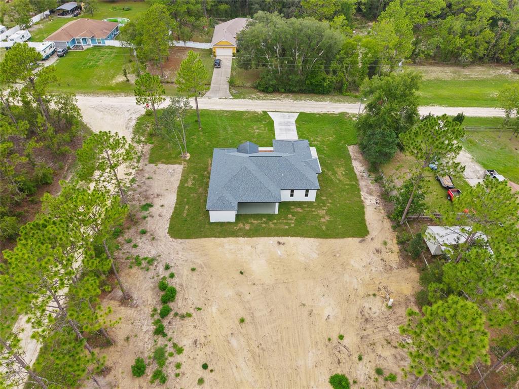 9789 Southwest 125th Ct Road Dunnellon, FL 34432 - Photo 8 of 37 an aerial view of a house with a yard and lake view