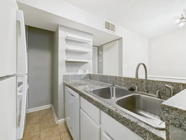 a kitchen with a sink and refrigerator