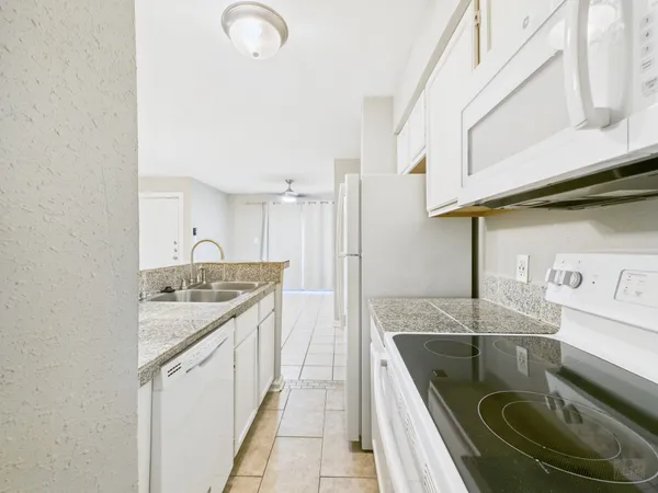 a kitchen with stainless steel appliances a sink and a refrigerator
