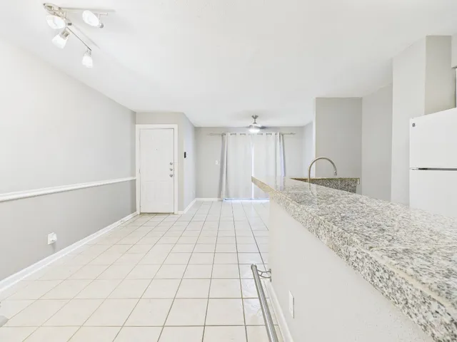 a kitchen with stainless steel appliances a sink and a refrigerator