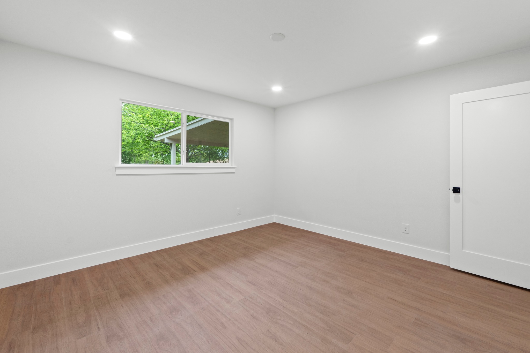 1608 Springer Lane Austin, TX 78758 - Photo 19 of 35 Interior room featuring wood-finish flooring, white walls, and recessed lighting