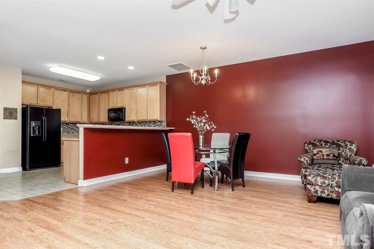 2112 Stoney Spring Drive Raleigh, NC 27610 - Photo 11 of 25 a kitchen with stainless steel appliances kitchen island granite countertop a refrigerator and a sink