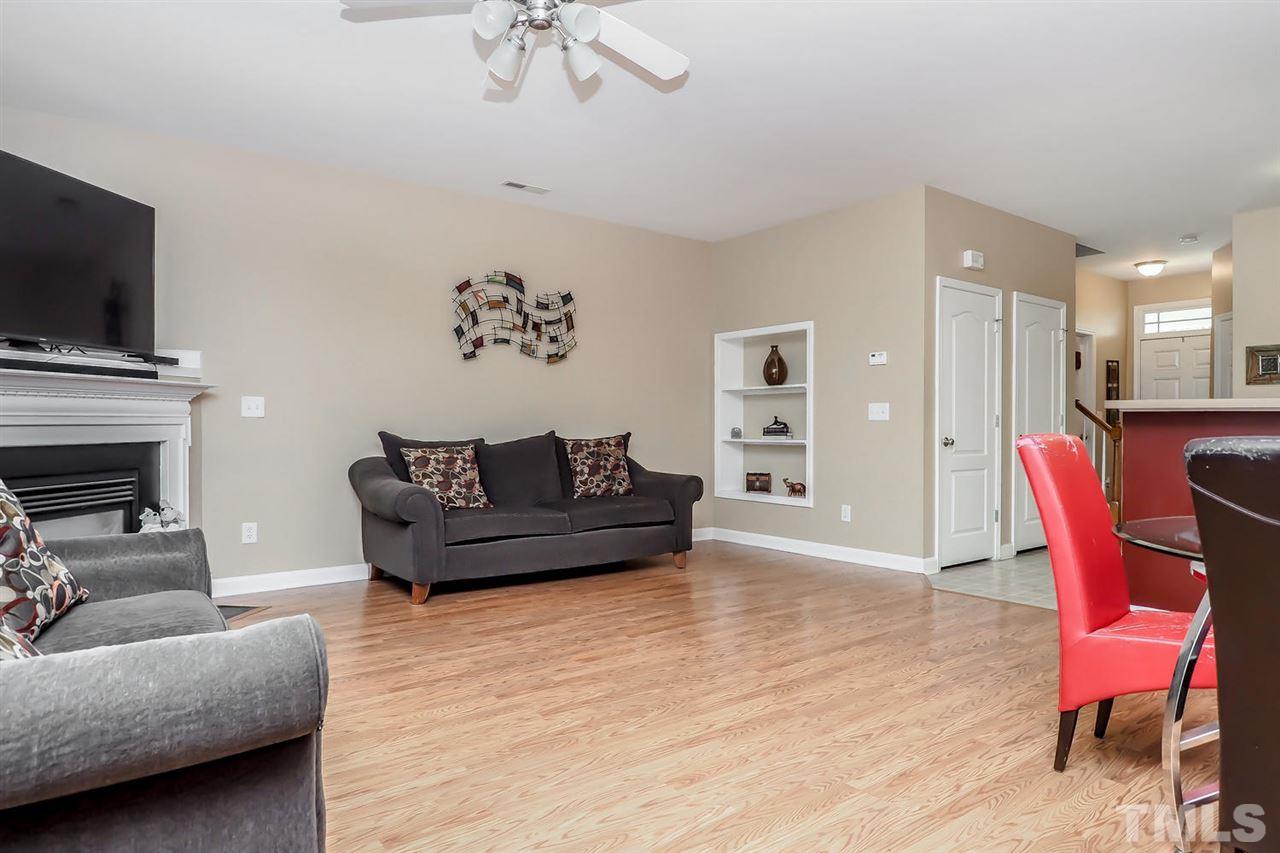 2112 Stoney Spring Drive Raleigh, NC 27610 - Photo 13 of 25 a living room with furniture and a flat screen tv