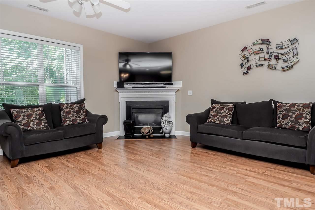 2112 Stoney Spring Drive Raleigh, NC 27610 - Photo 14 of 25 a living room with furniture flat screen tv and a fireplace