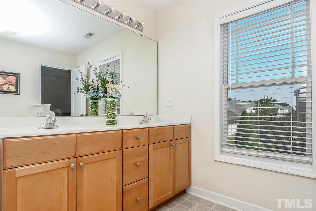 2112 Stoney Spring Drive Raleigh, NC 27610 - Photo 17 of 25 a bathroom with a sink and a mirror