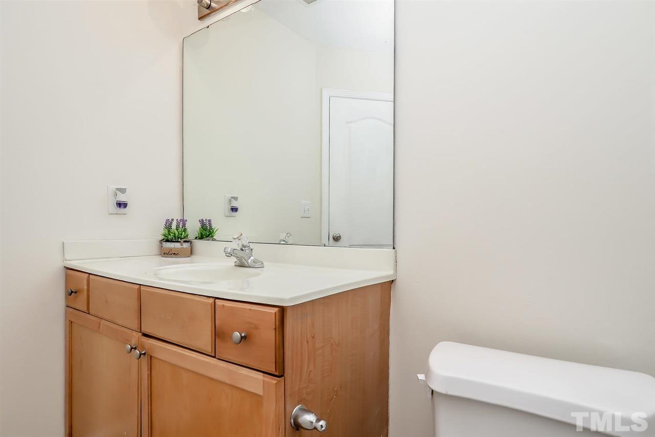 2112 Stoney Spring Drive Raleigh, NC 27610 - Photo 21 of 25 a bathroom with a sink a toilet and mirror