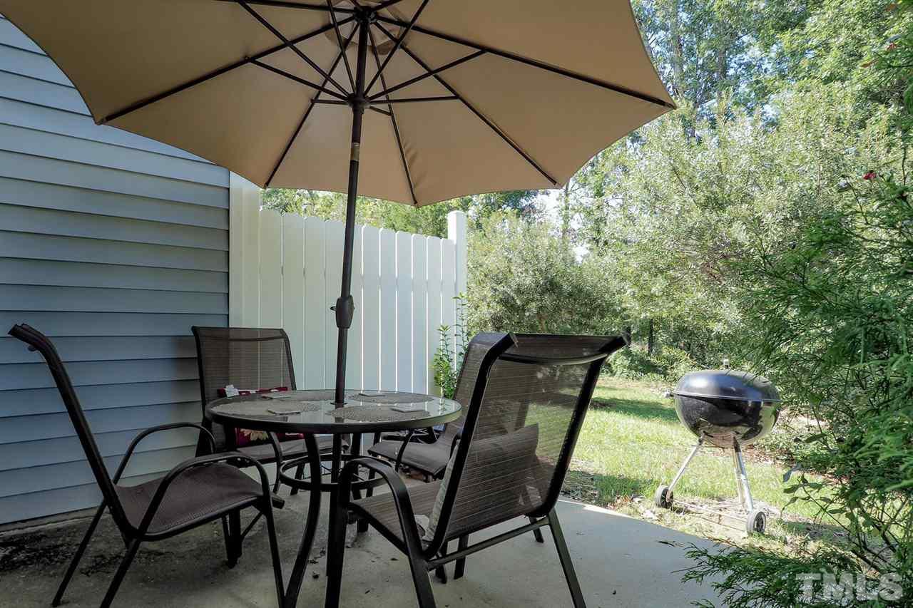 2112 Stoney Spring Drive Raleigh, NC 27610 - Photo 22 of 25 a view of an outdoor sitting area with furniture and umbrella