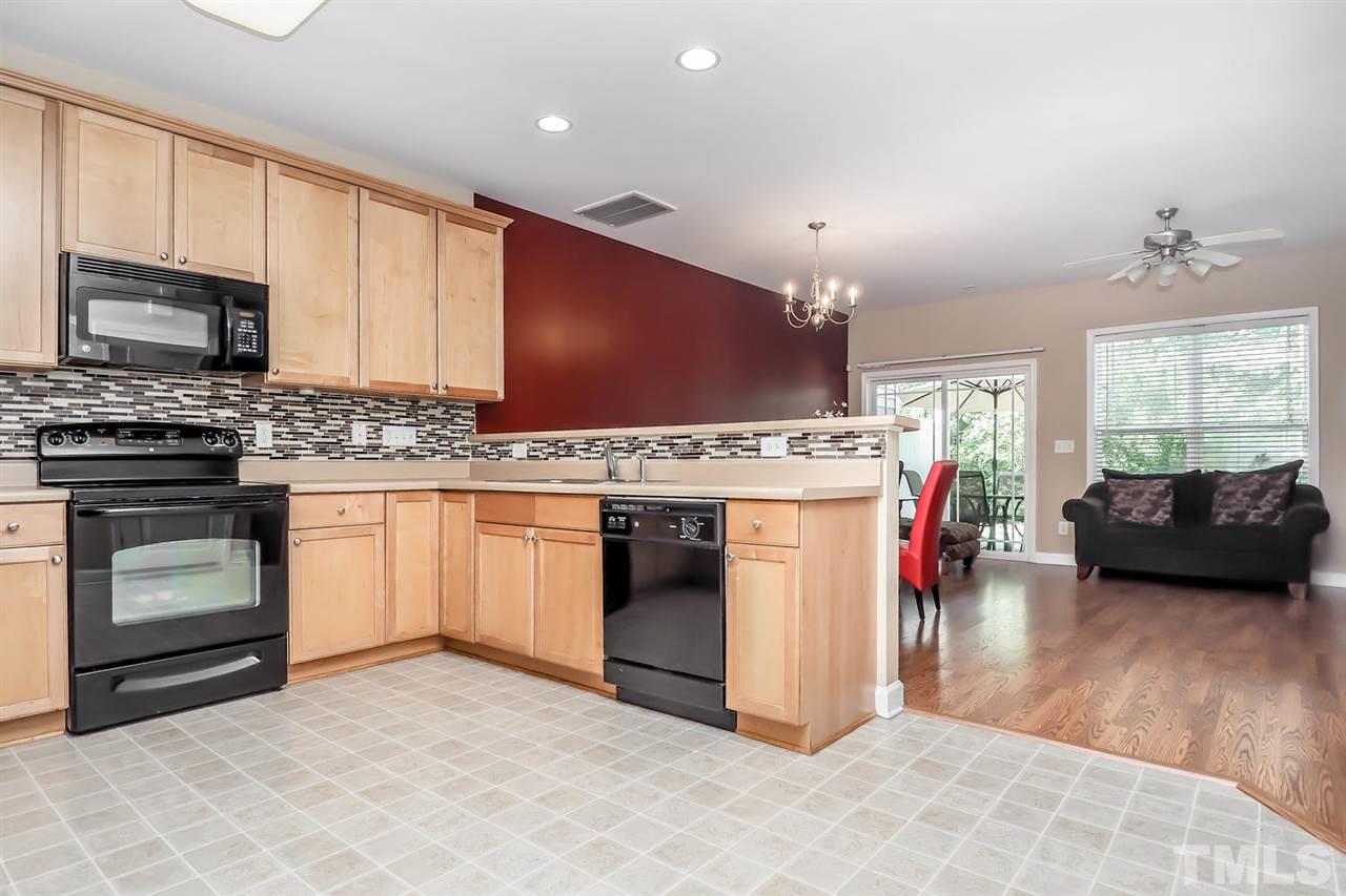 2112 Stoney Spring Drive Raleigh, NC 27610 - Photo 7 of 25 a kitchen with stainless steel appliances granite countertop a stove a sink and a microwave