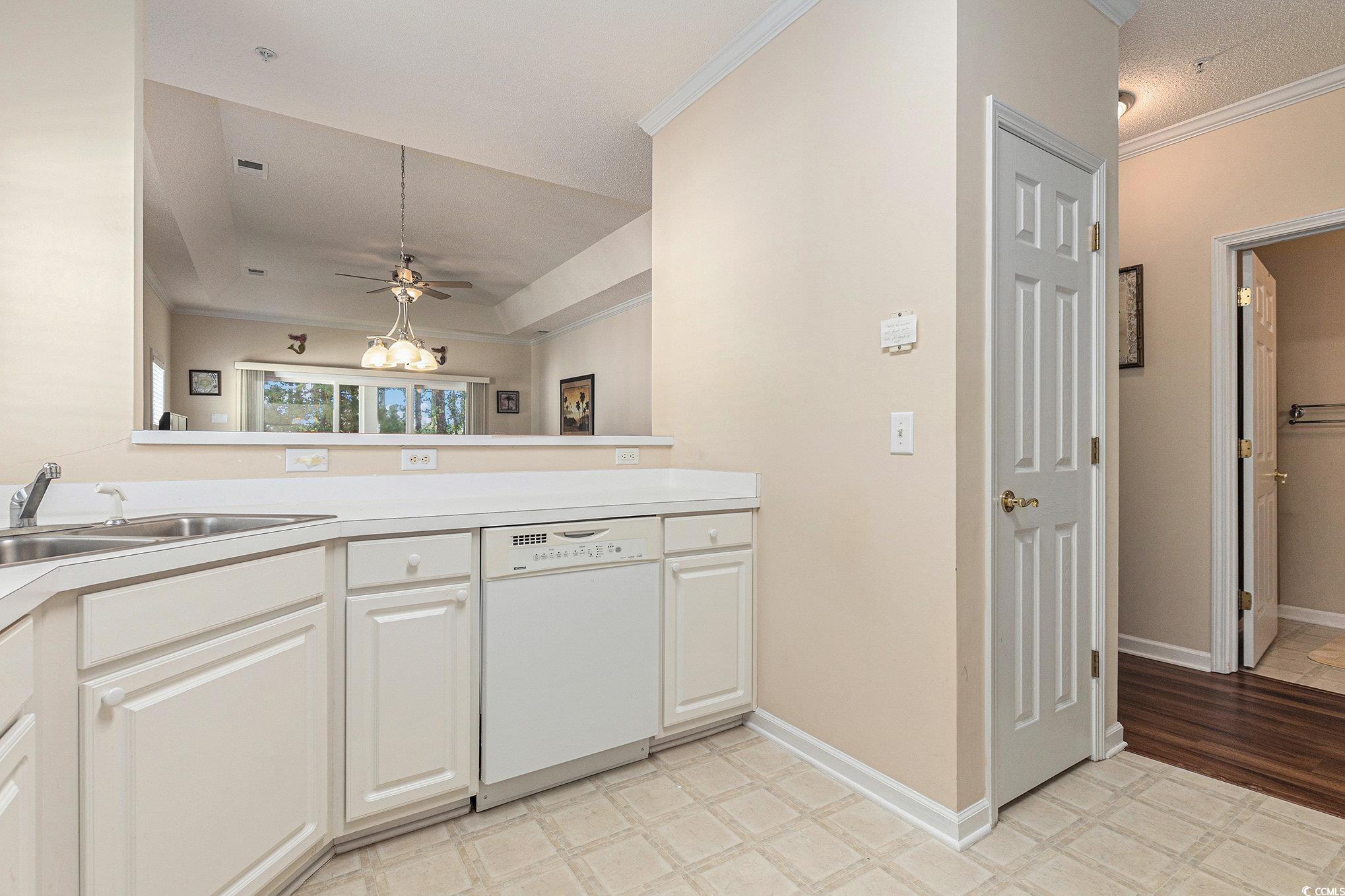 730 Charter Drive, Unit F11 Longs, SC 29568 - Photo 13 of 32 Kitchen featuring white appliances, crown molding, light countertops, plenty of natural light, and hanging light fixtures