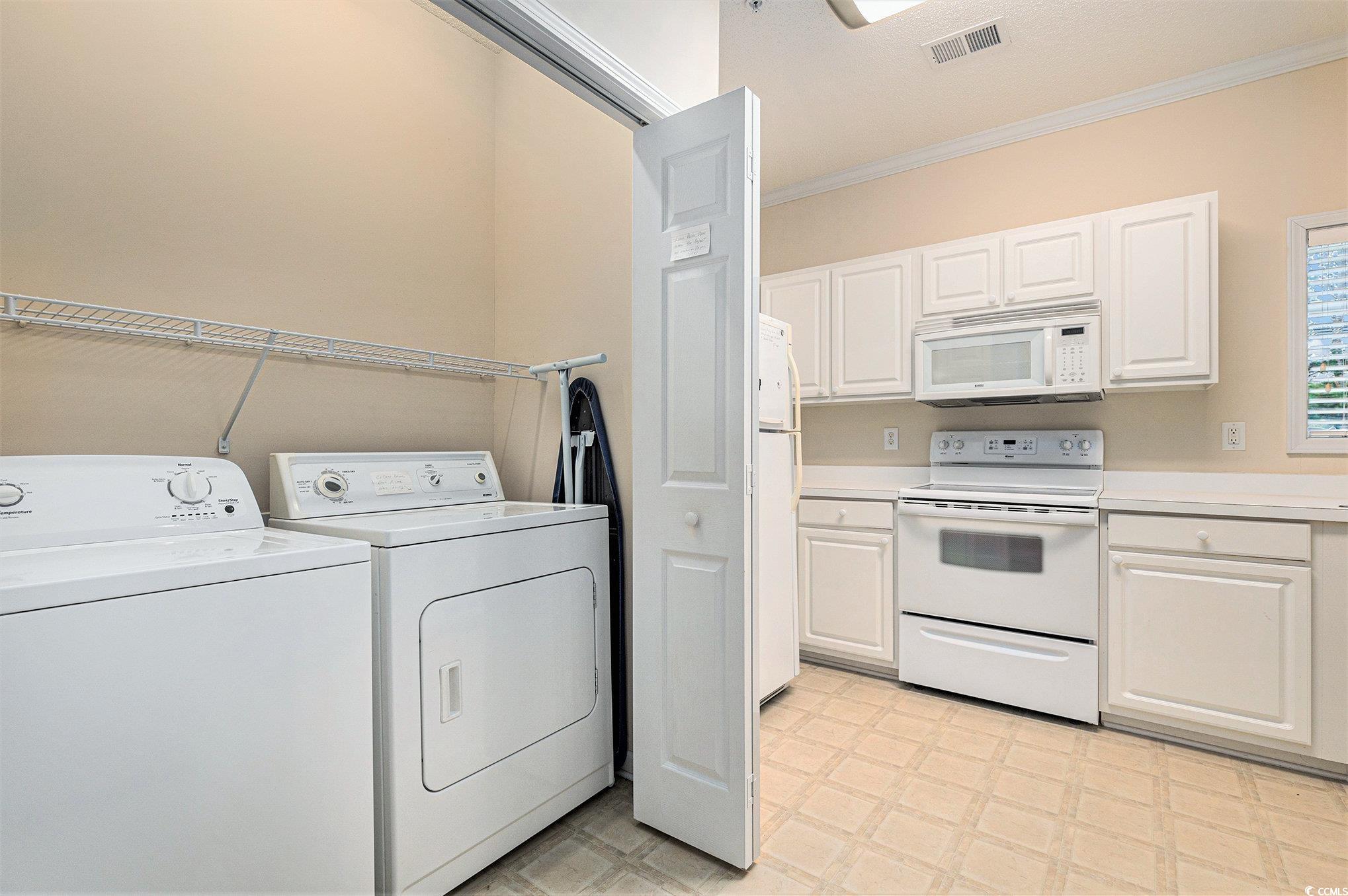 730 Charter Drive, Unit F11 Longs, SC 29568 - Photo 14 of 32 Kitchen featuring crown molding, dishwasher, light countertops, white cabinetry, and a ceiling fan