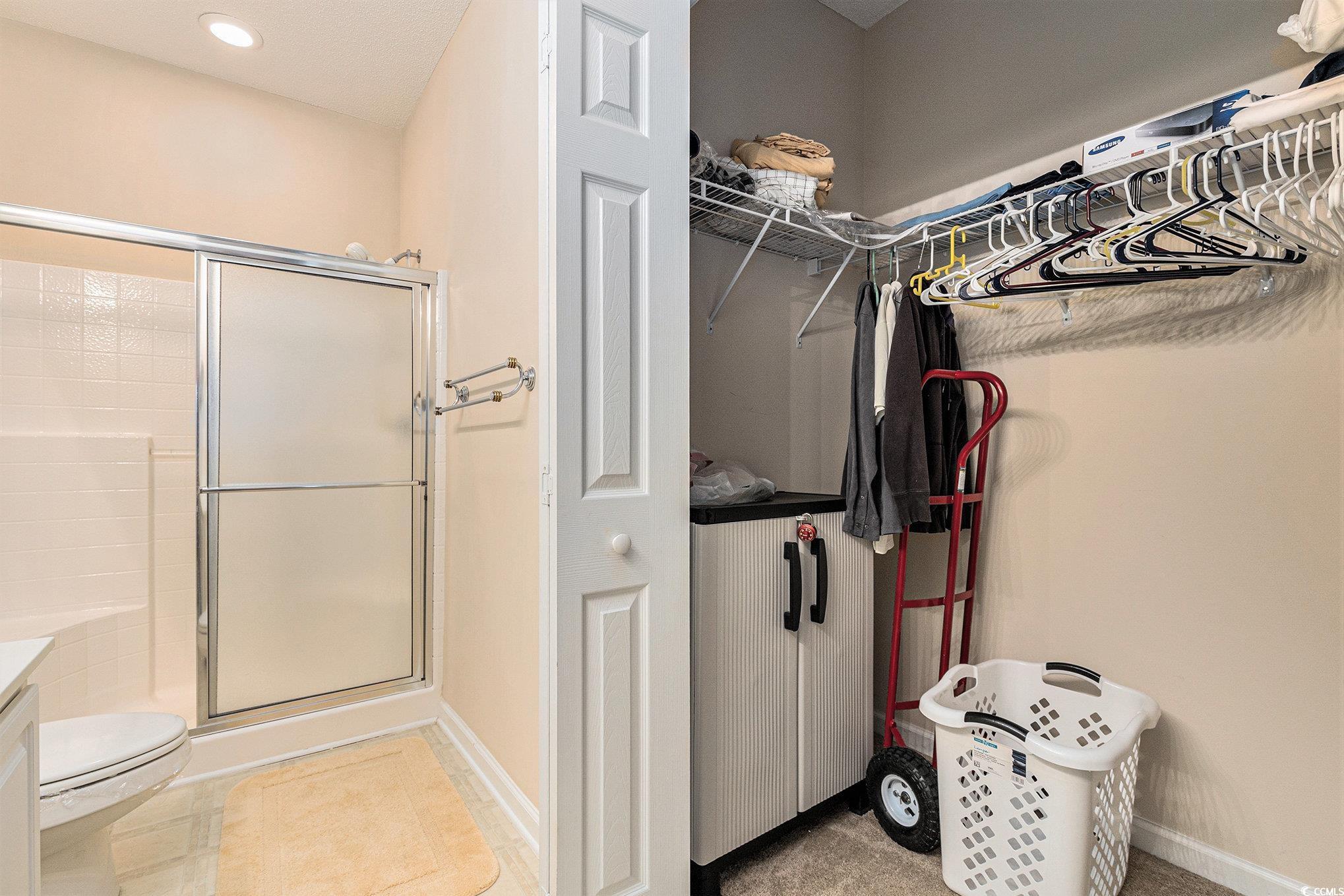 730 Charter Drive, Unit F11 Longs, SC 29568 - Photo 20 of 32 Full bathroom featuring a walk in closet, a shower stall, double vanity, and recessed lighting