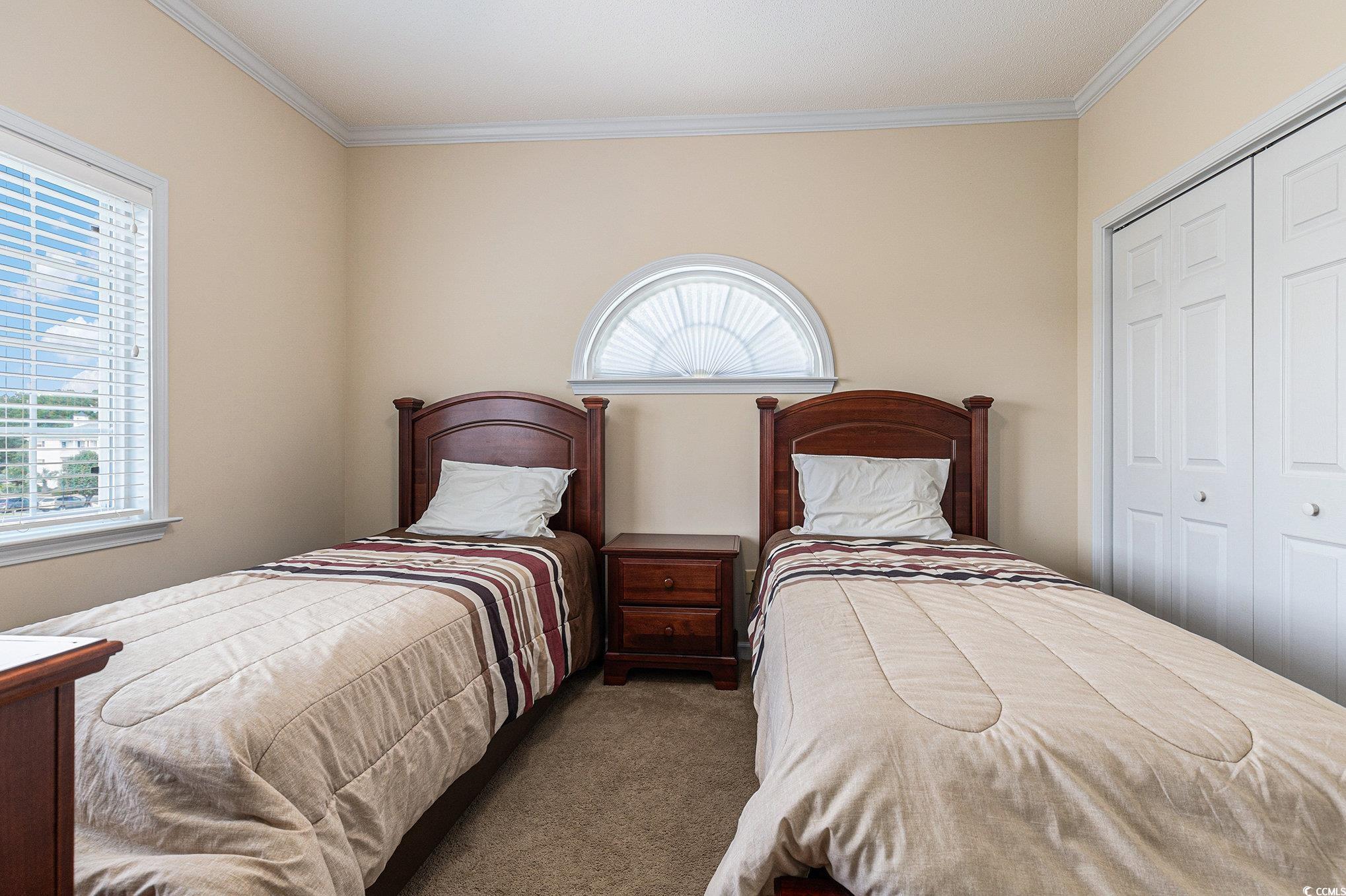 730 Charter Drive, Unit F11 Longs, SC 29568 - Photo 22 of 32 Bedroom with carpet floors, ornamental molding, a closet, and ceiling fan