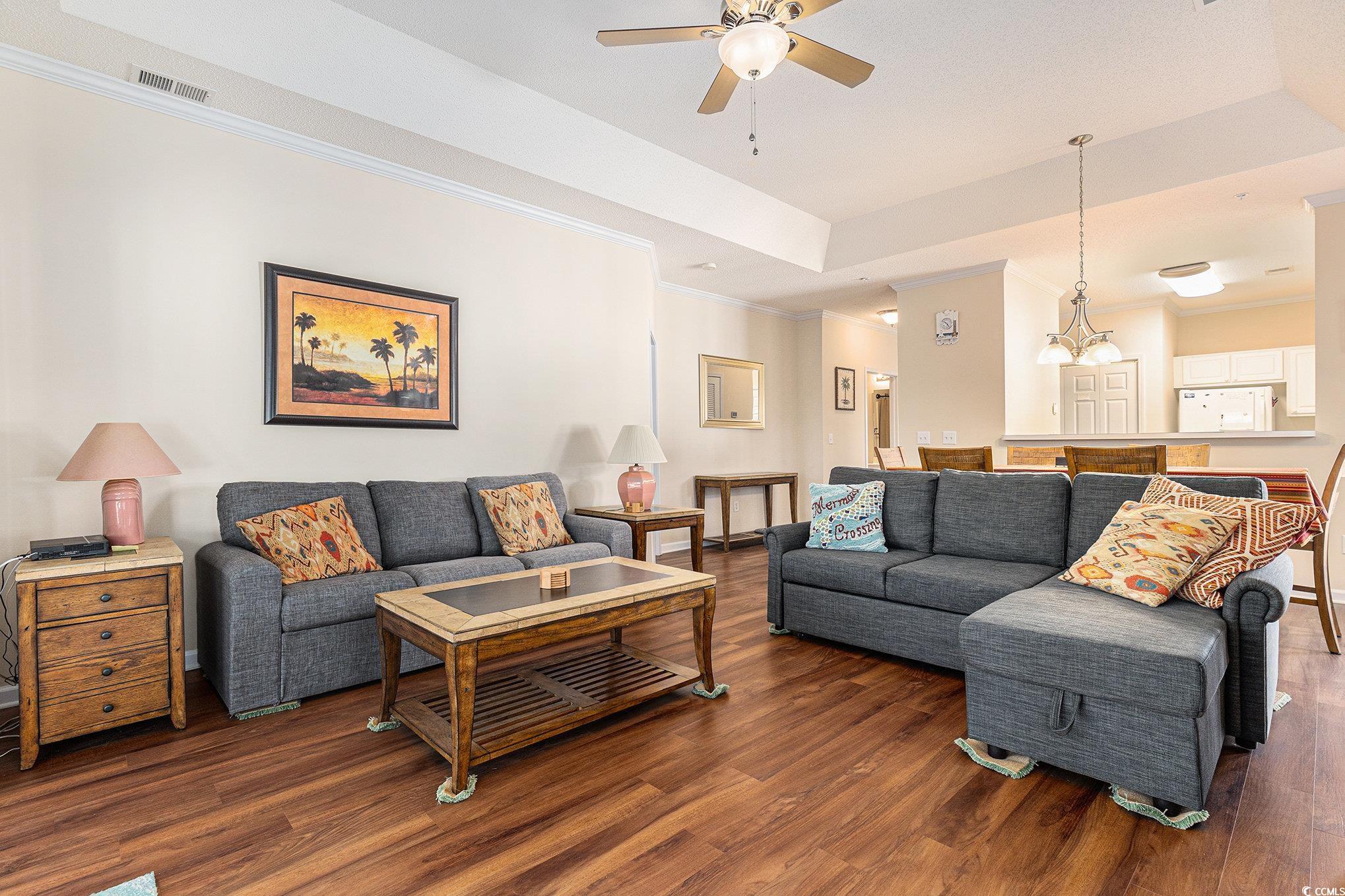730 Charter Drive, Unit F11 Longs, SC 29568 - Photo 5 of 32 Living room featuring wood finished floors, a tray ceiling, and crown molding