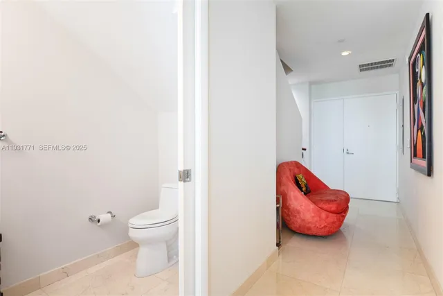 a bathroom with a toilet and a shower curtain
