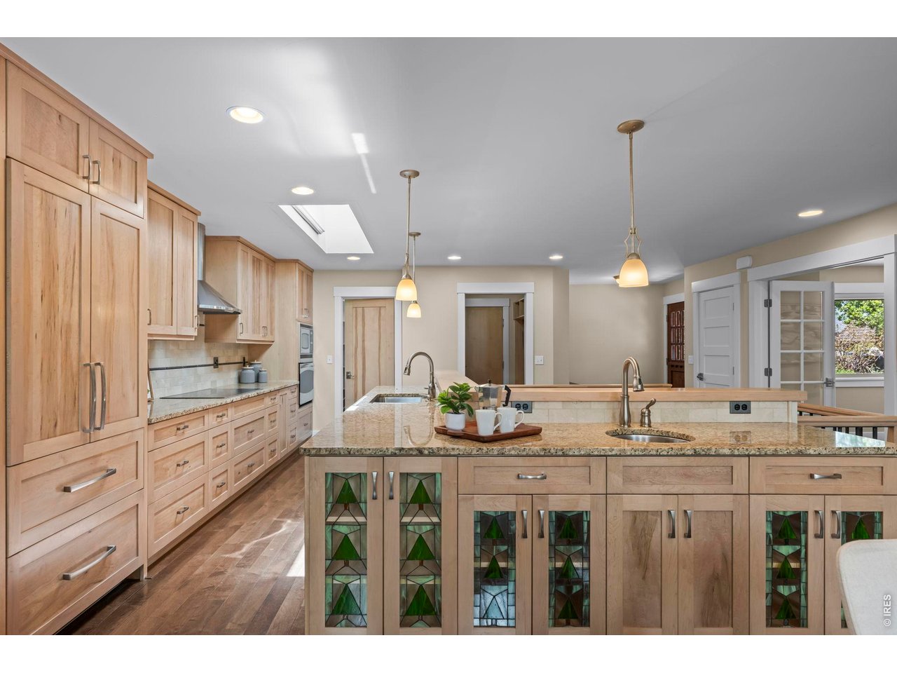 4824 Briar Ridge Court Boulder, CO 80301 - Photo 6 of 40 a kitchen with kitchen island granite countertop white cabinets and stainless steel appliances