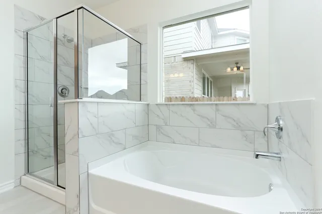 a bathroom with a double vanity sink a mirror and a shower