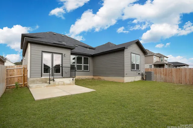 a view of house with backyard