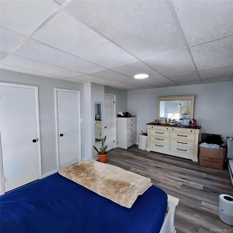 a living room with kitchen view and a wooden floor