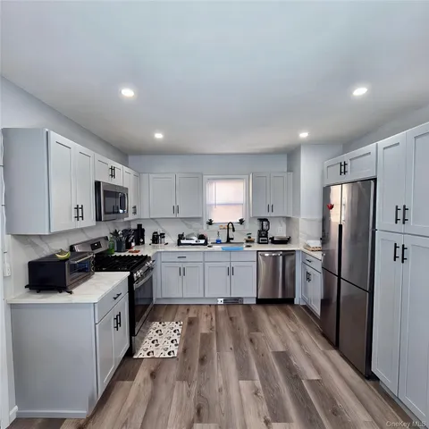 a kitchen with refrigerator a sink and cabinets