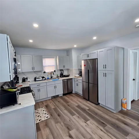 a kitchen with a refrigerator a sink and cabinets