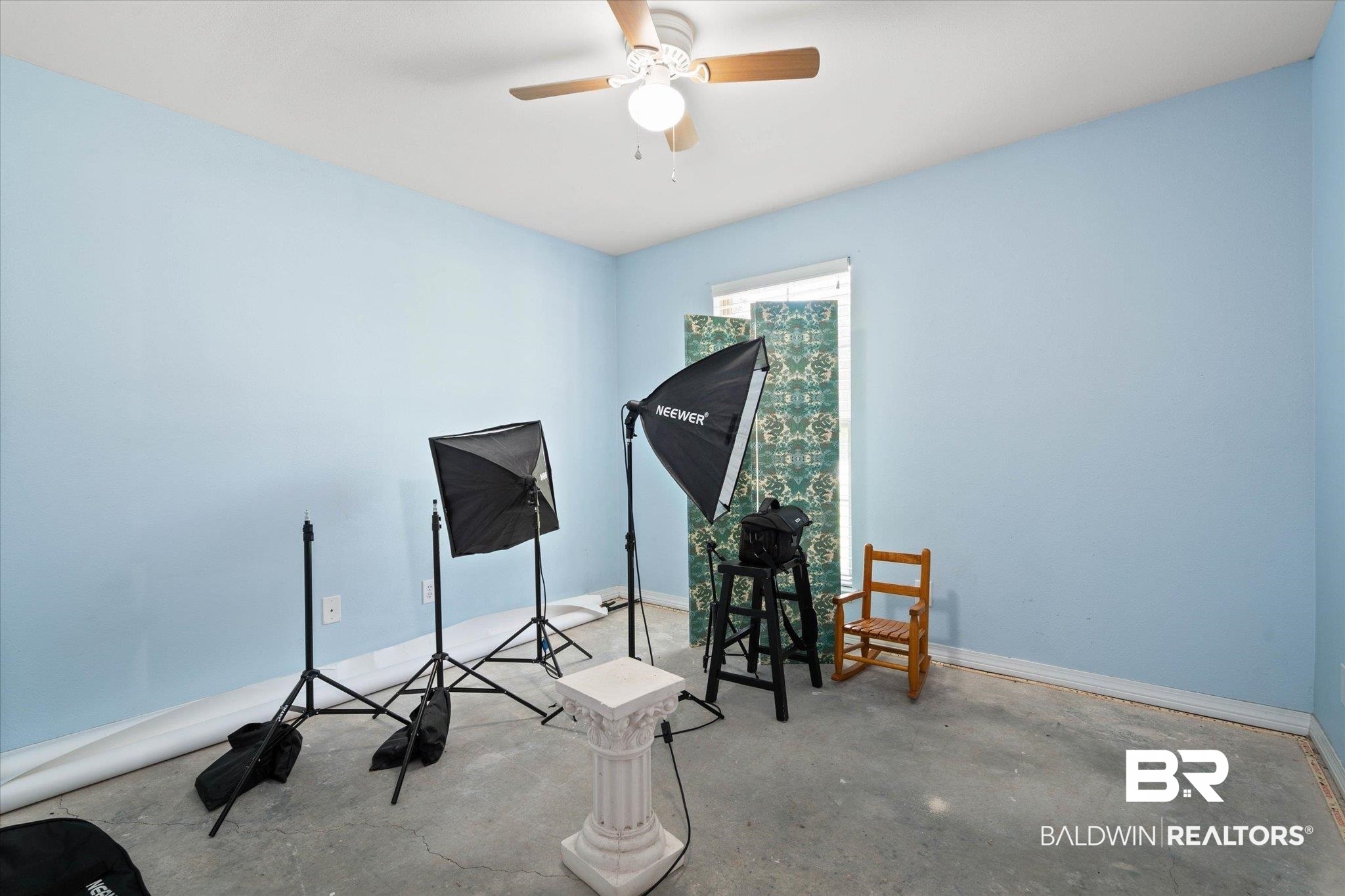 1411 Creola Axis Loop Road North Axis, AL 36505 - Photo 16 of 21 Miscellaneous room featuring unfinished concrete flooring, ceiling fan, and baseboards