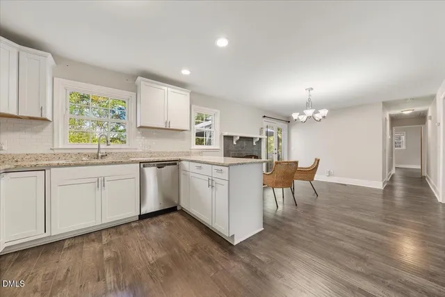 a kitchen with a sink cabinets and wooden floor