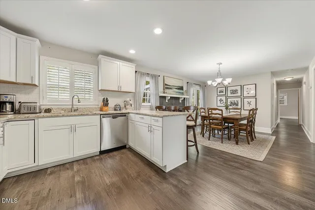 a kitchen with white cabinets counter top space and stainless steel appliances
