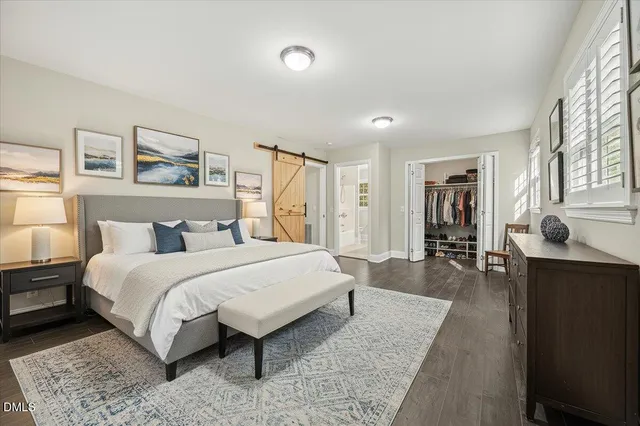 a spacious bedroom with a bed and a couch