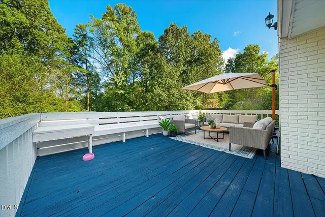 a backyard of a house with table and chairs