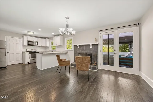a dining room with furniture and wooden floor