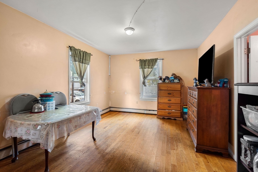 90 Timson Street Lynn, MA 01902 - Photo 11 of 38 a view of a livingroom with furniture and a flat screen tv