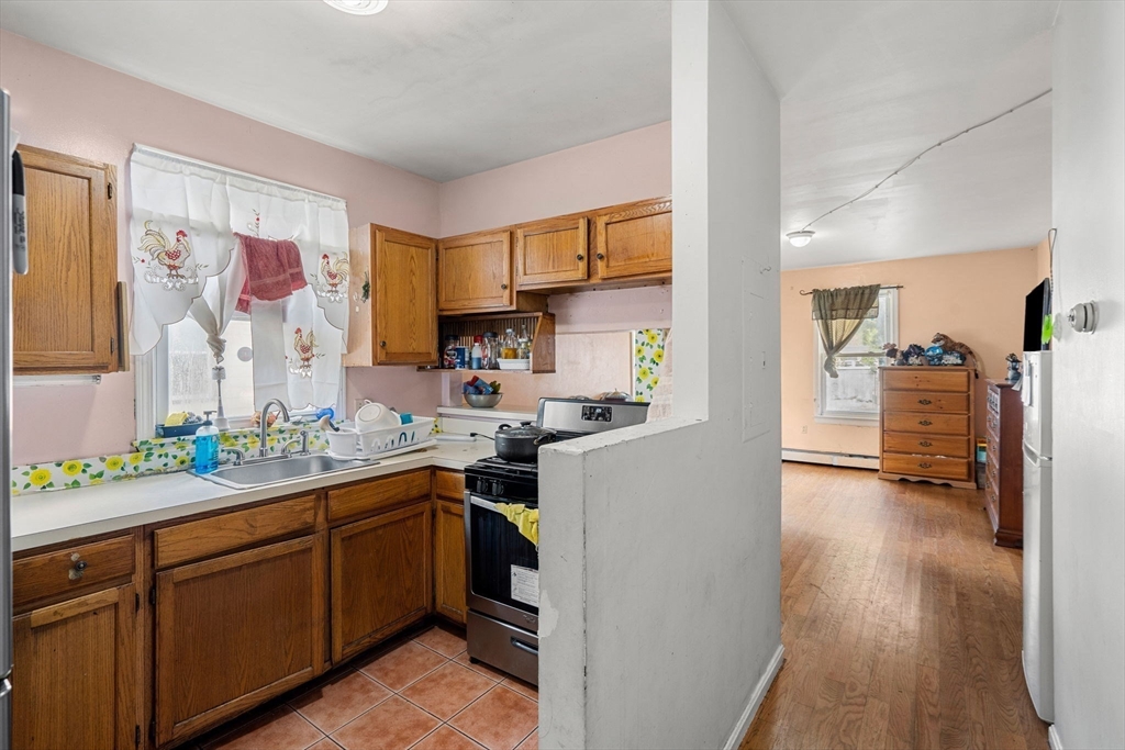 90 Timson Street Lynn, MA 01902 - Photo 13 of 38 a kitchen with a sink and cabinets