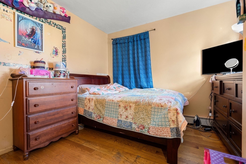 90 Timson Street Lynn, MA 01902 - Photo 16 of 38 a bed room with a bed and a television