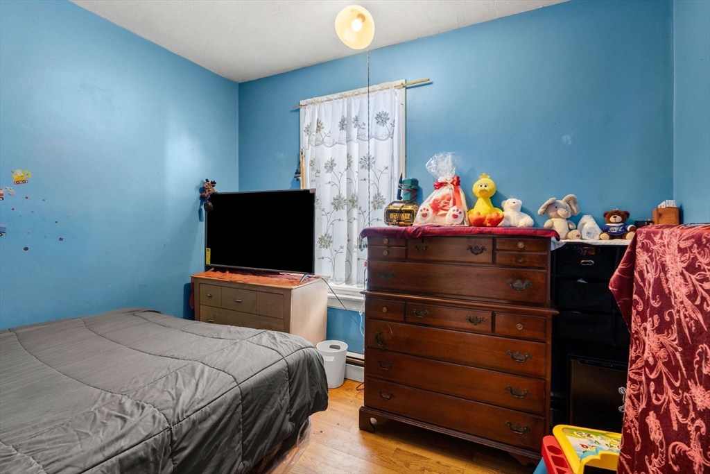 90 Timson Street Lynn, MA 01902 - Photo 17 of 38 a bedroom with a bed and a television